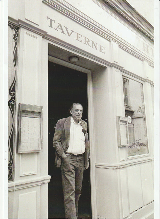 Photograph of Charles Bukowski in Front of Taverne