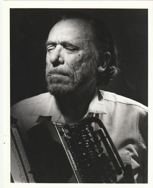 Photograph (8” x 10”) of Charles Bukowski Holding Vintage Typewriter